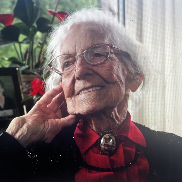 An elderly woman smiling at home